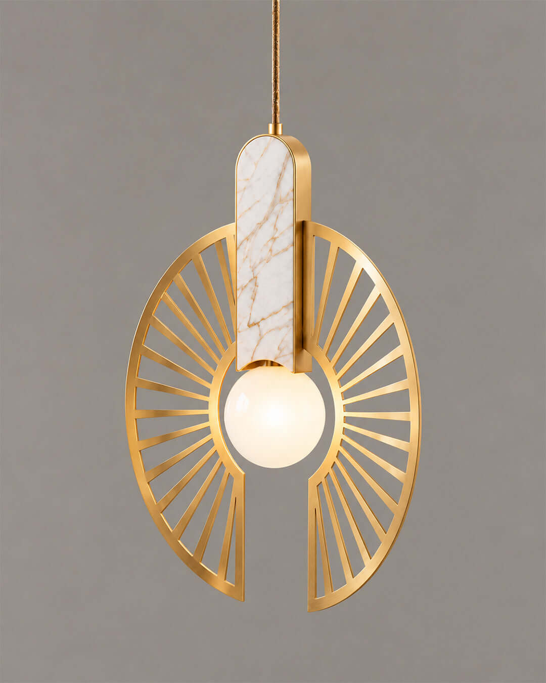 Solaris Pendant — close view of golden sunburst and glowing globe | دلاية سولاريس، لقطة مقربة لدائرة ذهبية مفتوحة وكرة مضيئة