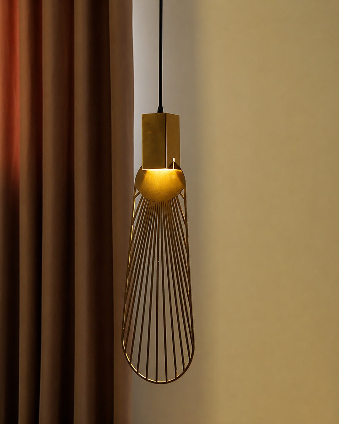 Aten Pendant Modern Gold Lighting Fixture hanging in a stylish interior, offering warm illumination.