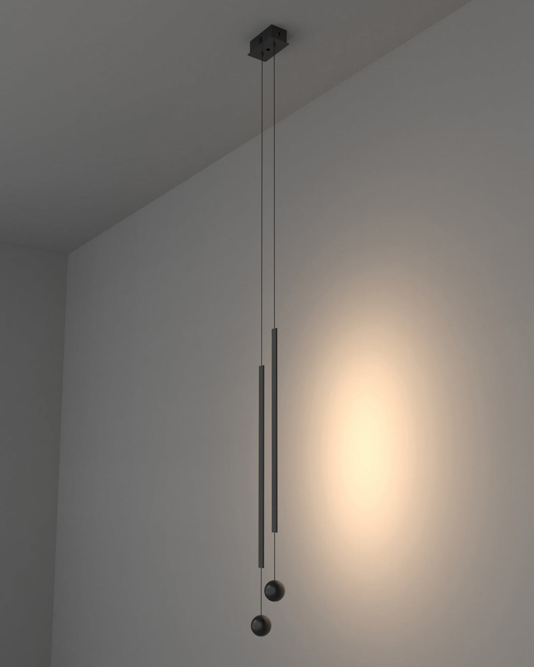 Two lines pendant light with slim vertical black rods creating warm ambient lighting / إضاءة معلقة بخطين بتصميم طولي نحيف باللون الأسود تضيف إضاءة دافئة وعصرية