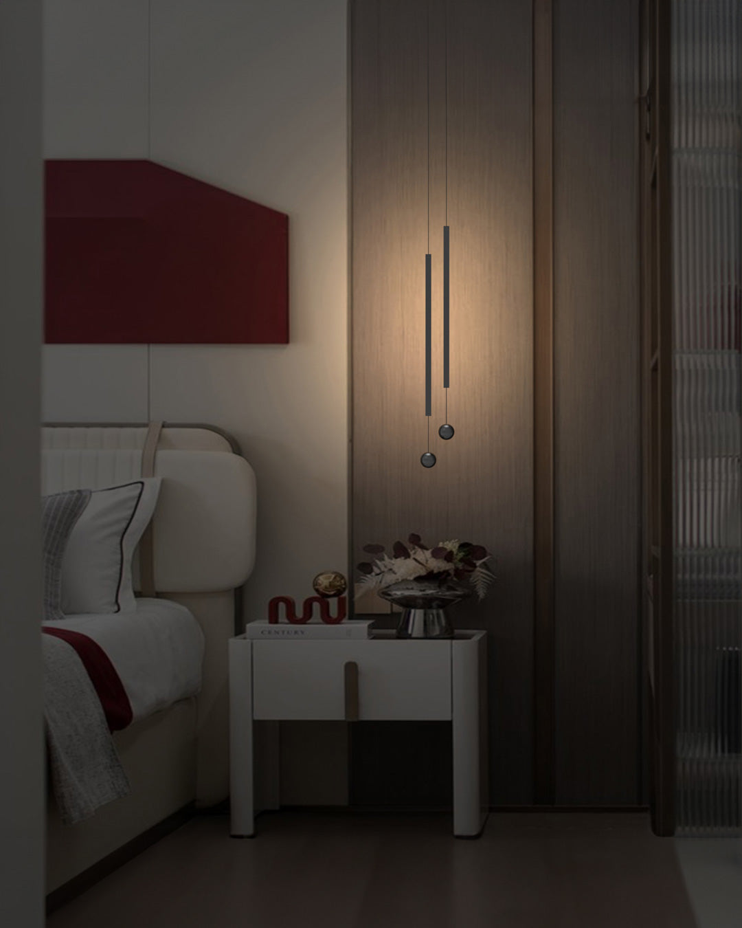 Two lines pendant light with slim vertical black rods creating warm ambient lighting / إضاءة معلقة بخطين بتصميم طولي نحيف باللون الأسود تضيف إضاءة دافئة وعصرية