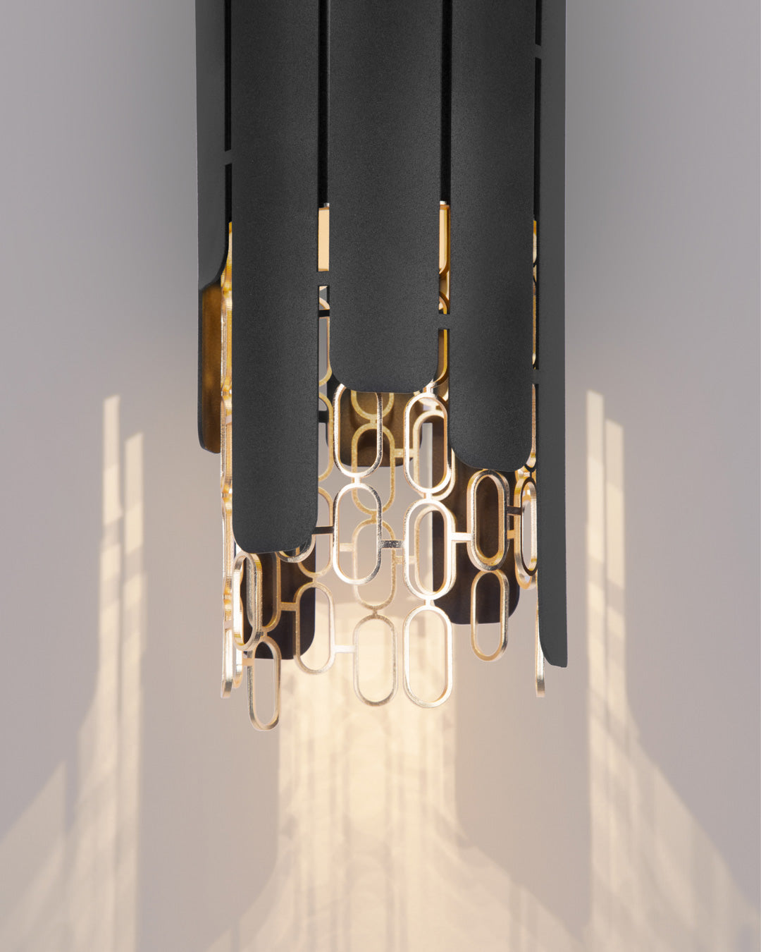 Chain inspired wall lamp with rhythmic flowing form casting soft indirect light / مصباح حائط بتصميم متسلسل إيقاعي يبعث إضاءة غير مباشرة ناعمة