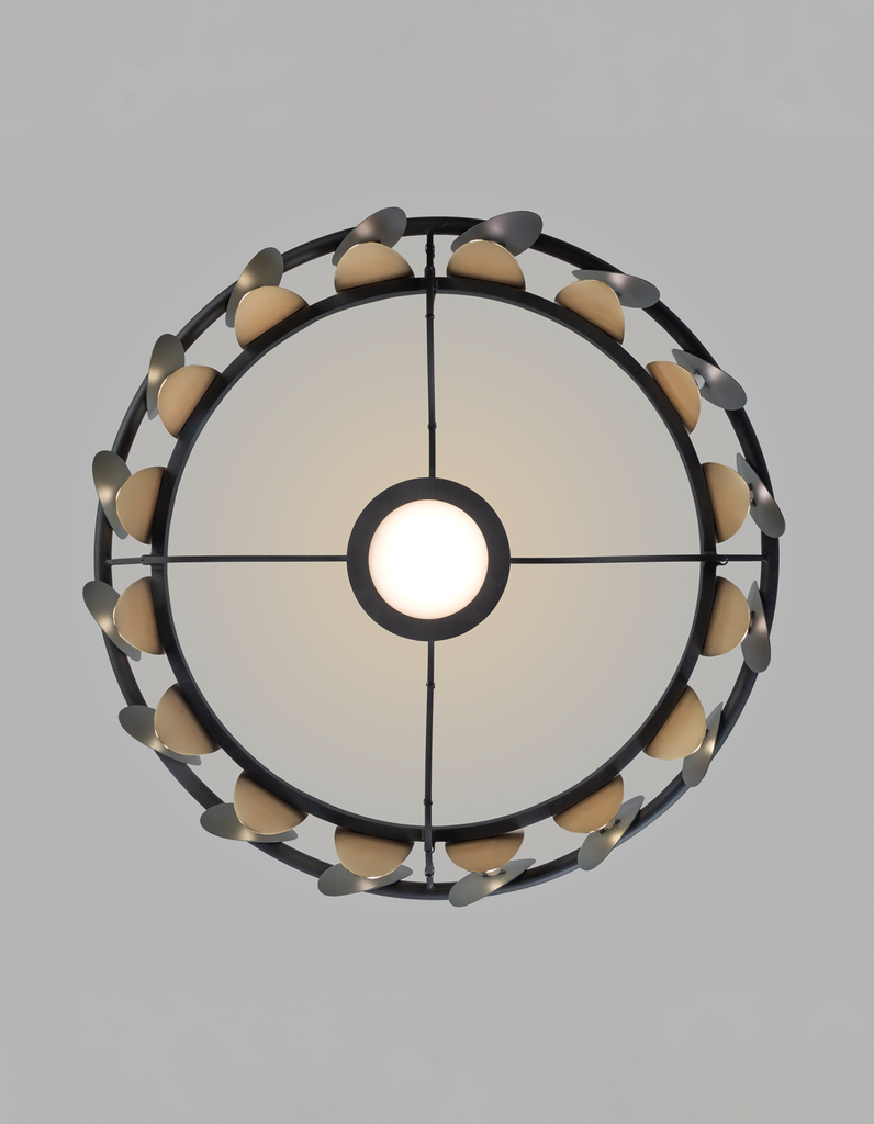 Oval pendant light with butterfly wing inspired form casting soft ambient light / إضاءة معلقة بتصميم بيضاوي مستوحى من أجنحة الفراشة تبعث إضاءة ناعمة