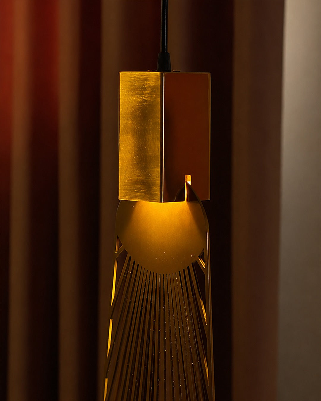 Aten Pendant Modern Gold Lighting Fixture hanging elegantly, providing warm illumination in a contemporary setting.